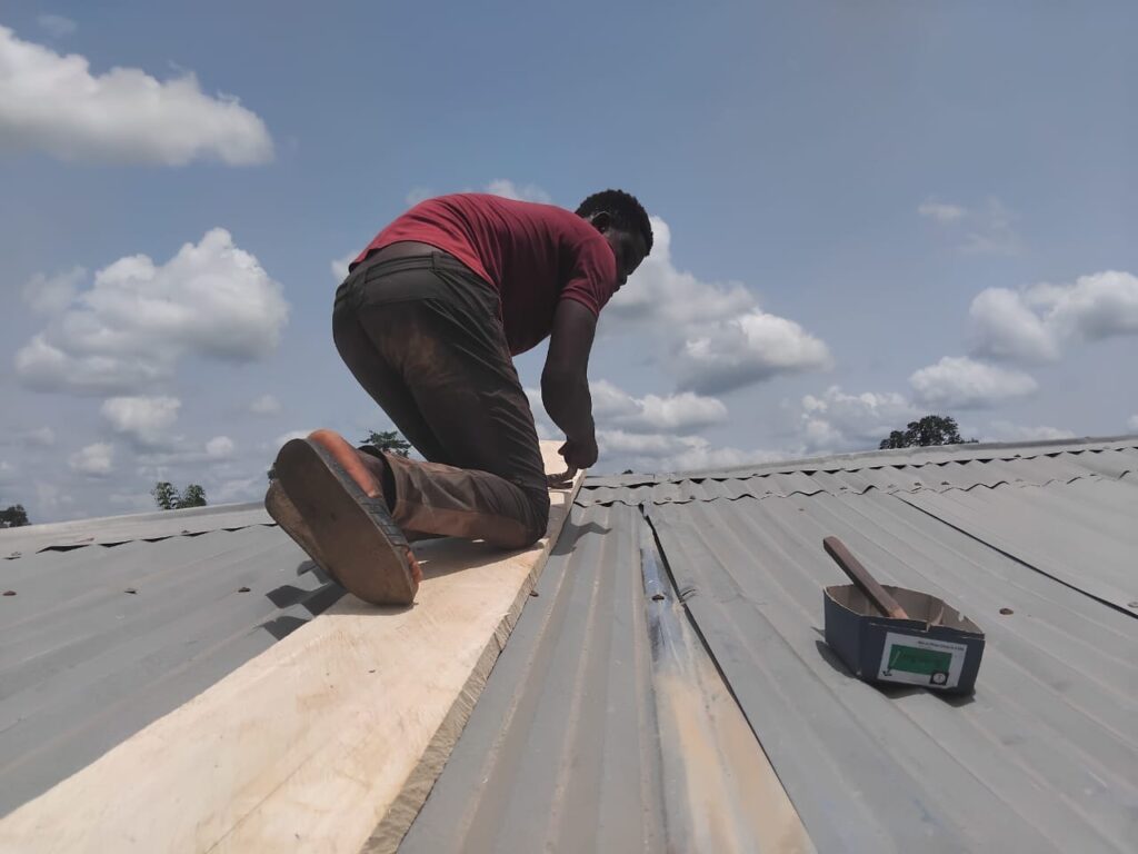 Precarious yet necessary work repairing the roofs.